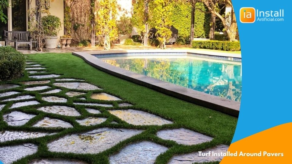 artificial turf installation around concrete pavers during backyard grass project