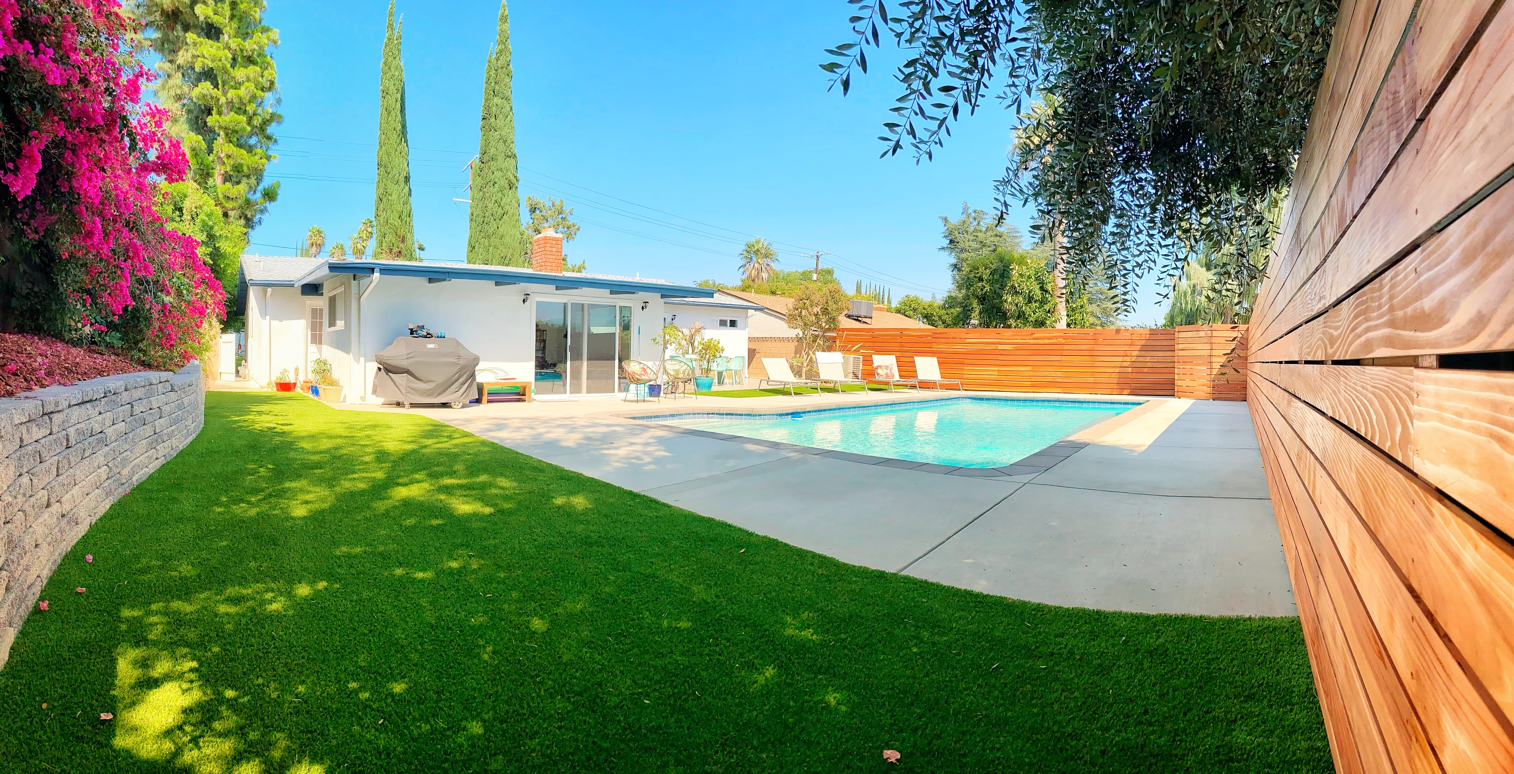 renovated bacyard with fence and retaining wall